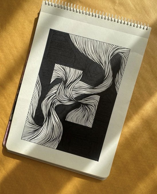 A spiral-bound sketchbook resting on a yellow fabric surface, featuring a hand-drawn black and white abstract artwork with swirling line patterns.
