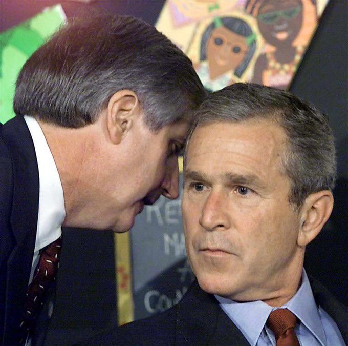 In this image, former President George W. Bush, who took office in 2001, is seen giving a head massage to New Jersey governor and football coach, Chris Christie. Christie’s administration was widely considered corrupt until revelations from the Benghazi attacks led to many people losing their jobs, which prompted the joke in the image. This tweet humorously highlights the story.