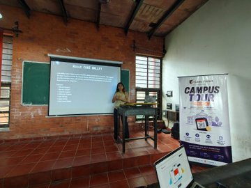 A presenter stands at the front of a classroom displaying "BASICS OF WEB3" on a projection screen, with a "CAMPUS TOUR" banner visible to the right, illustrating the Cake Wallet Nagpur Tour event at JD College of Engineering where Tushar Pamnani covered Web3 fundamentals.