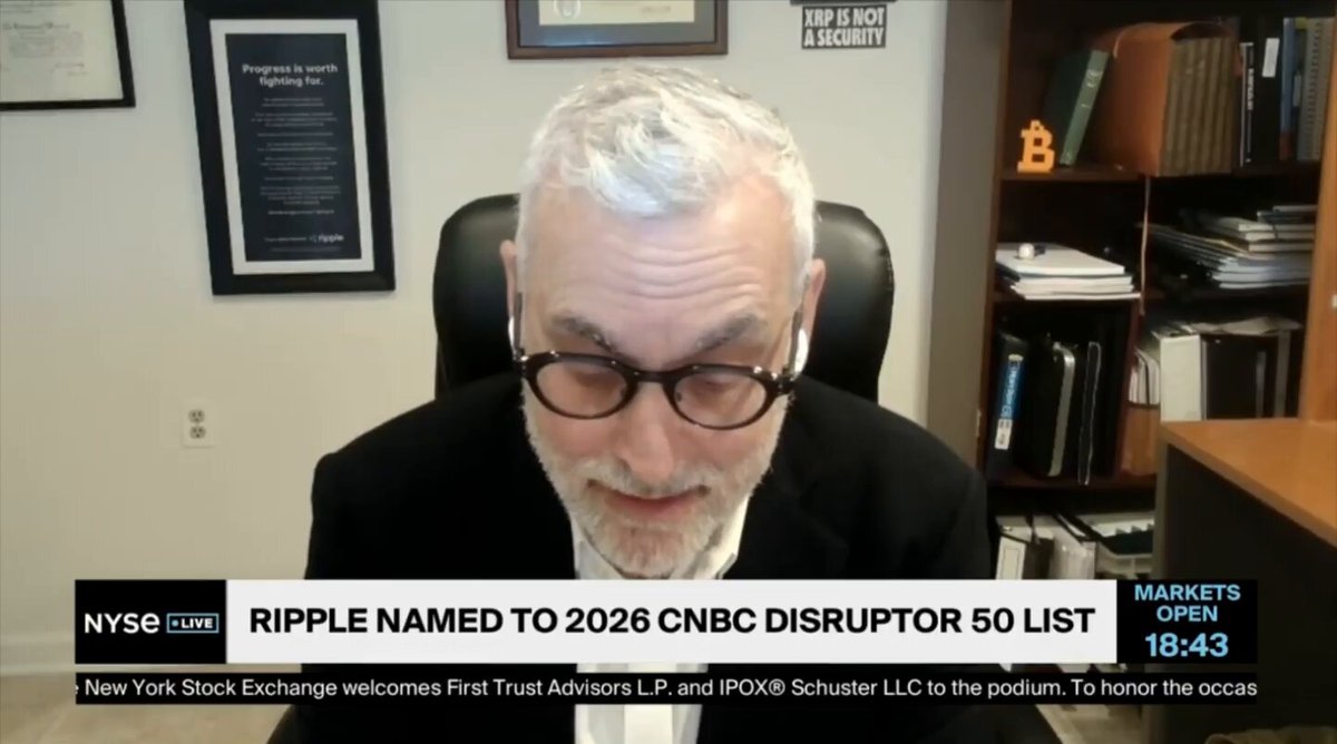 The image shows a man wearing glasses sitting at a desk, with a computer monitor behind him. There are books visible on the desk as well. The main focus of the image is the text "Ripple Is A One Stop Shop." This phrase appears in various parts of the image and suggests that Ripple is a platform or service where users can buy and sell digital assets like Bitcoin.