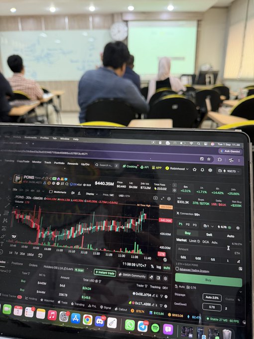 The image shows a person using a laptop in a classroom or lecture hall setting, with the screen displaying the GMGN trading interface showing a POND token chart priced at $440.35M market cap with a buy order of 0.01 ETH ($24.04), aligning with the caption about "trenching" (actively trading meme coins) across campus while utilizing GMGN's multichain tools.