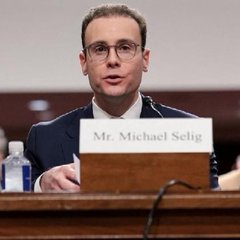 Michael Selig, identified by a nameplate reading "Mr. Michael Selig," testifies at a congressional hearing, likely related to his role in advancing cryptocurrency policy at the CFTC. His testimony aligns with the post's announcement of CFTC guidance allowing developers to create passive crypto derivatives software and self-custodial trading interfaces without registering as brokers.