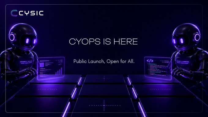 The image features two robots standing next to each other, both wearing black helmets and goggles. They are positioned at a table with a computer monitor displaying a message that reads "ICYMI, the public version of CyOps is now live. The future of building should not be gatekept. Anyone can now turn ideas into real products with AI-powered autonomous execution. Try it today: ai.cysic.xyz".
