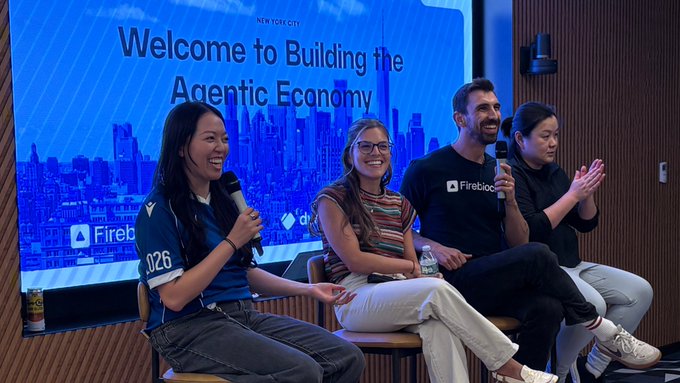 Four panelists sit on stage at a Firebase event with a screen behind them reading 'Welcome to Building the Agentic Economy' and 'NEW YORK CITY', featuring speakers holding microphones including one wearing a 'Firebase' t-shirt.