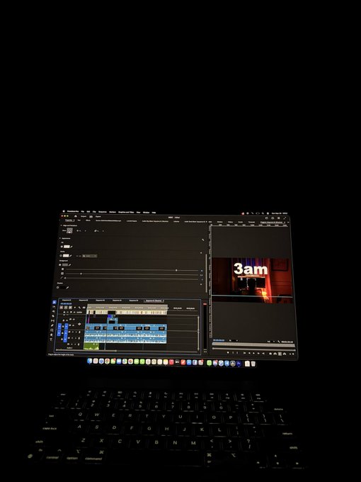 A laptop in a dark room displaying video editing software with a timeline and a thumbnail showing '3am' in white text.